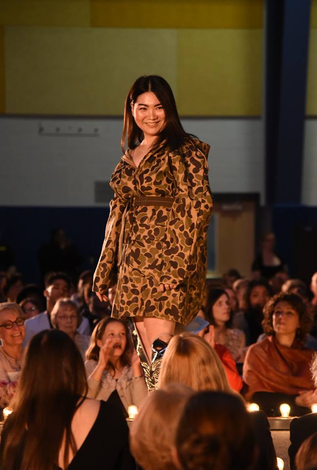 Female student wearing a camouflage jacket.