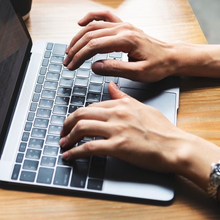 hands on a laptop keyboard