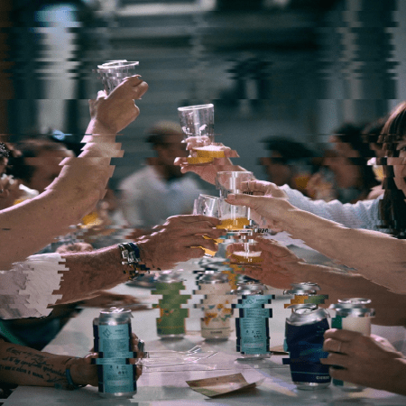 blurred photo of people raising glasses in a social setting